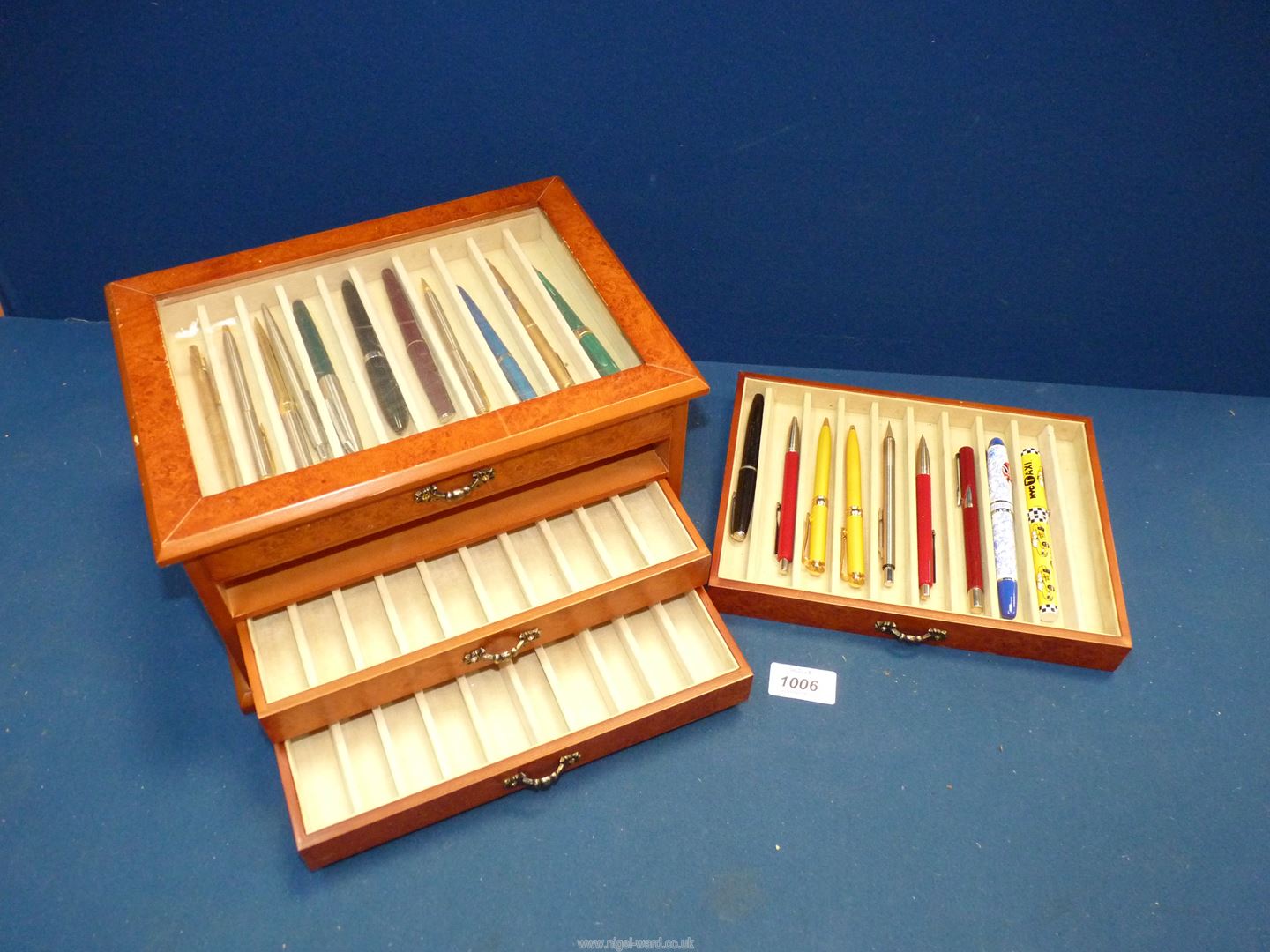 A glass topped drawer cabinet with assorted pens including; Osmiroid with 14k nib,
