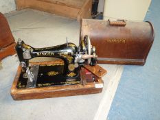 A Singer hand sewing machine.