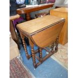 An Oak gateleg drop-leaf occasional Table standing on twist legs,