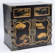 An attractive Oriental lacquered cabinet with chinoiserie decoration of birds and foliage,