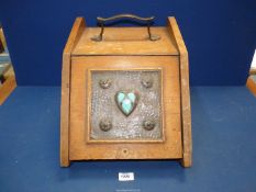 A light oak Coal Scuttle with metal liner and having a square Arts & Crafts beaten copper panel