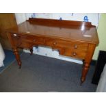 A Satinwood circa 1900 Writing/Dressing Table standing on turned legs and having brass and brown
