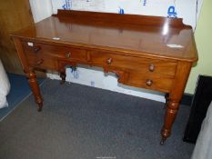 A Satinwood circa 1900 Writing/Dressing Table standing on turned legs and having brass and brown