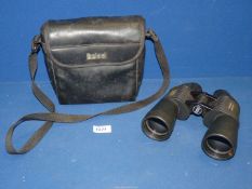 A pair of Bushnell Perma Focus 12 x 50 binoculars in soft case.