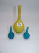 A pair of small onion vases in plain turquoise together with a larger vase of similar shape in