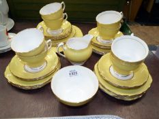A quantity of Colclough teaware in yellow including eight cups, eleven saucers,