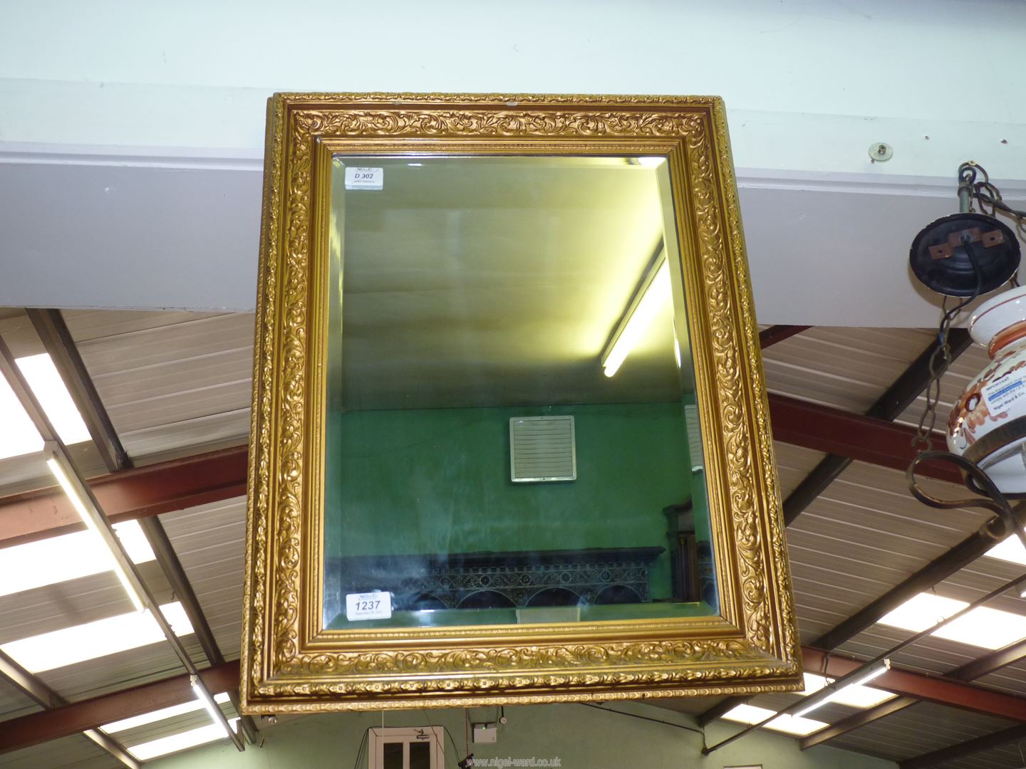 A gesso and gold coloured framed rectangular Wall Mirror having bevelled glass,