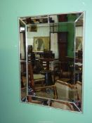 A rectangular wall hanging Mirror having bevelled glass and framed with an eight bevelled mirror
