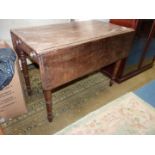 A circa 1900 Mahogany Pembroke Table standing on turned legs and having a frieze drawer to one end,