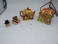 An old cottage style teapot and matching biscuit barrel,