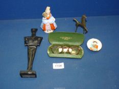 A black cast metal figure and a small bronze horse****, a small figure of a lady,