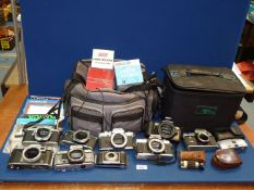 Two camera bags containing camera bodies including; Canon EO5 500 with lanyard, Minolta XG-M,
