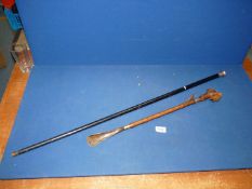 An ebonised walking stick with Birmingham silver top and a shoe horn,