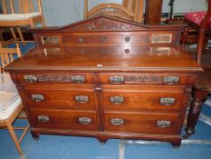 A Walnut/Mahogany Sideboard having an upstand including a pair of bevelled mirror panels,