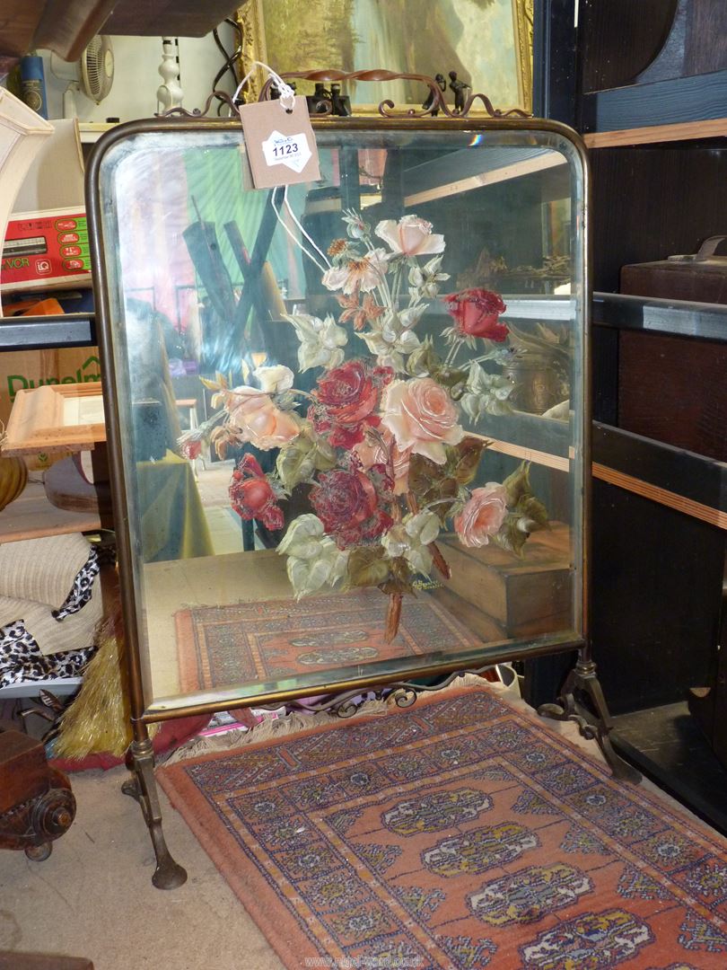 A mirrored Firescreen having painted red and pink roses, signature G. Bourter, 19" wide x 27" high.