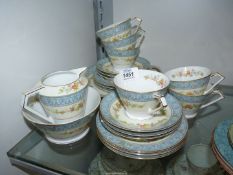 A Noritake tea service (no teapot) decorated with cream bands having floral pattern within a pale