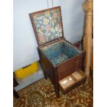 A Mahogany Workbox standing on square legs and having a work storage compartment with a hinged lid