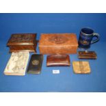 A tray containing an embossed leather box containing four wallets and a card case,