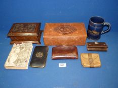 A tray containing an embossed leather box containing four wallets and a card case,