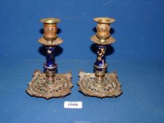 A pair of metal Candlesticks having ceramic stems painted with spider on web by T&T reg no: 92376.