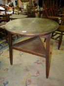 A period Cricket Table of principally Elm construction, the legs united by a triangular lower shelf,