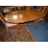 A very stylish "Ercol" Elm oval extending Dining Table standing on unusual club shaped legs united