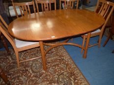 A very stylish "Ercol" Elm oval extending Dining Table standing on unusual club shaped legs united