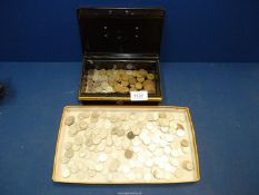 A quantity of threepence pieces and a quantity of sixpences in a cash tin.