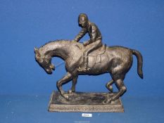 A heavy cast model of a horse and jockey, 18'' x 16'' high.