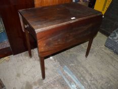 An extremely heavy Rosewood Pembroke Table standing on tapering square legs terminating in brass