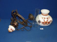 A ceiling hanging oil lamp, converted to electric with ceramic shade and glass chimney.