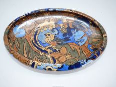 A Bursleyware 'Amstel' bowl designed by Frederick Rhead and standing on four lion's paw feet and