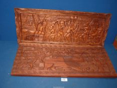 Two contemporary carved hard wood panels; one depicting Indians hunting a lion 28" x 11 1/2",