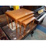 A nest of three occasional Tables standing on turned legs,