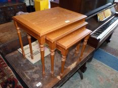 A nest of three occasional Tables standing on turned legs,