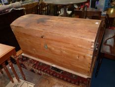 A dome topped Pine chest of tapering shaped and having a separate lift-out internal tray and having