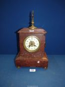 A two train movement French red marble mantle Clock with Arabic numerals having carrying handles to