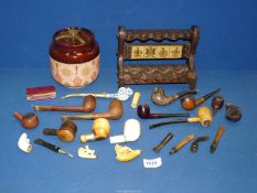 A tray containing briar and meerschaum pipes,