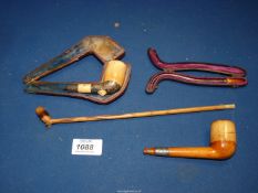 Two old pipes, one with a case (both a/f.) and a wooden pipe, 11" long.