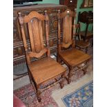 A pair of Oak solid seated Hall/side Chairs standing on turned front legs united by a turned