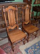 A pair of Oak solid seated Hall/side Chairs standing on turned front legs united by a turned