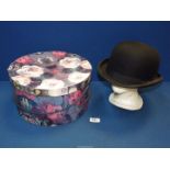 A Christy's London black bowler hat, size 7 3/8" in floral hat box.