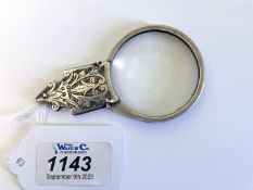 A magnifier with silver mount (originally the handle of a page turner), stamped Birmingham 1906,