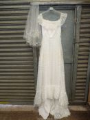 A 1980's wedding dress with veil and headpiece.