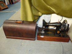 A Singer hand sewing machine, model no. ED948879 in wooden case.