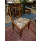 A Mahogany framed side chair standing on tapering square legs and having a floral-patterned drop-in