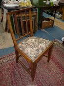 A Mahogany framed side chair standing on tapering square legs and having a floral-patterned drop-in