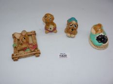 Three Pendelfin figures; 'Pooch', 'Rolly' and 'Poppet', plus a Pendelfin wall plaque.