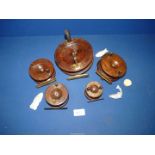 Five antique wooden fishing reels.