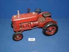 A red metal model tractor by Lesser and Pavey Ltd.